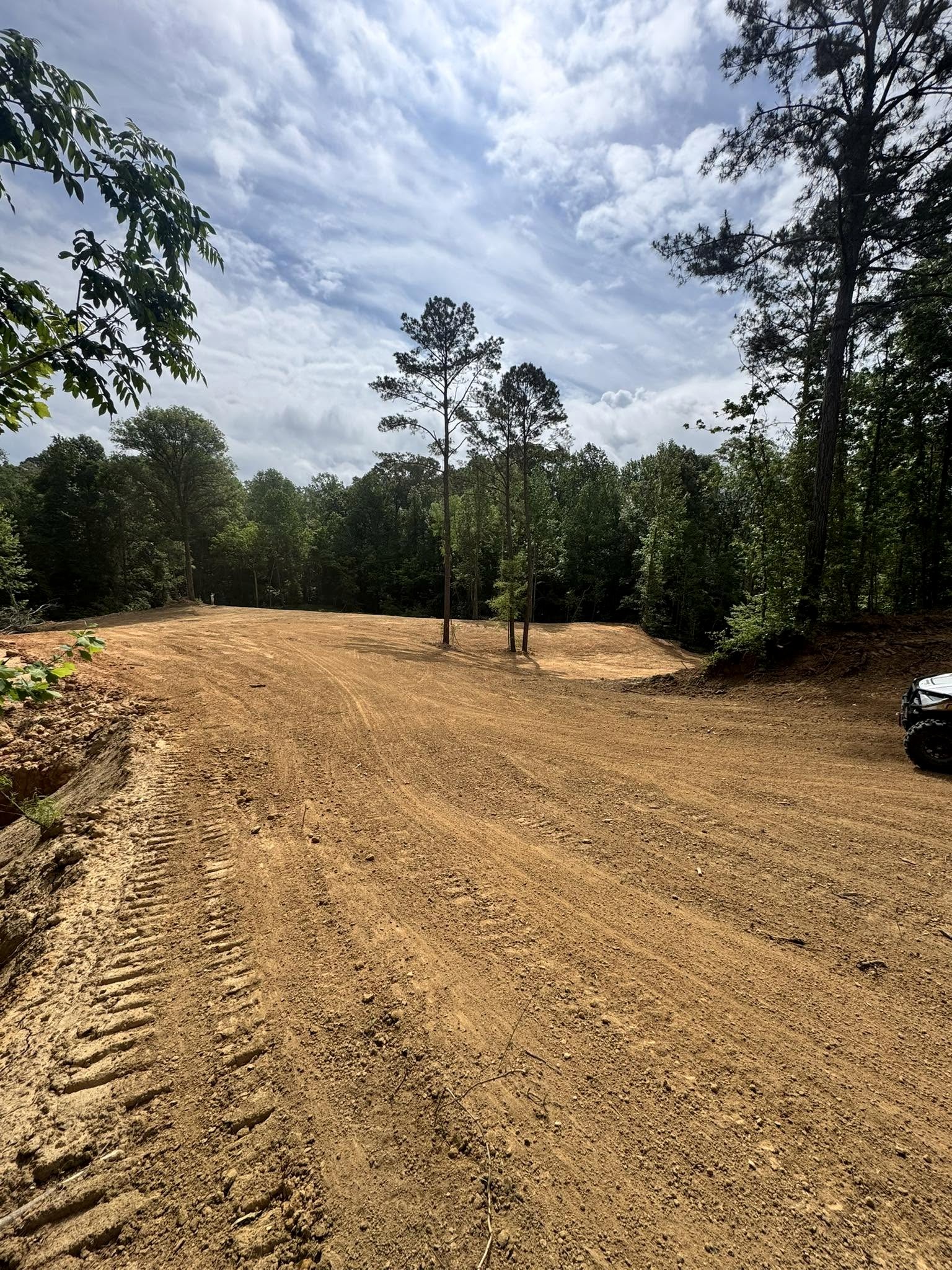 B&C graded clearing surrounded by woods